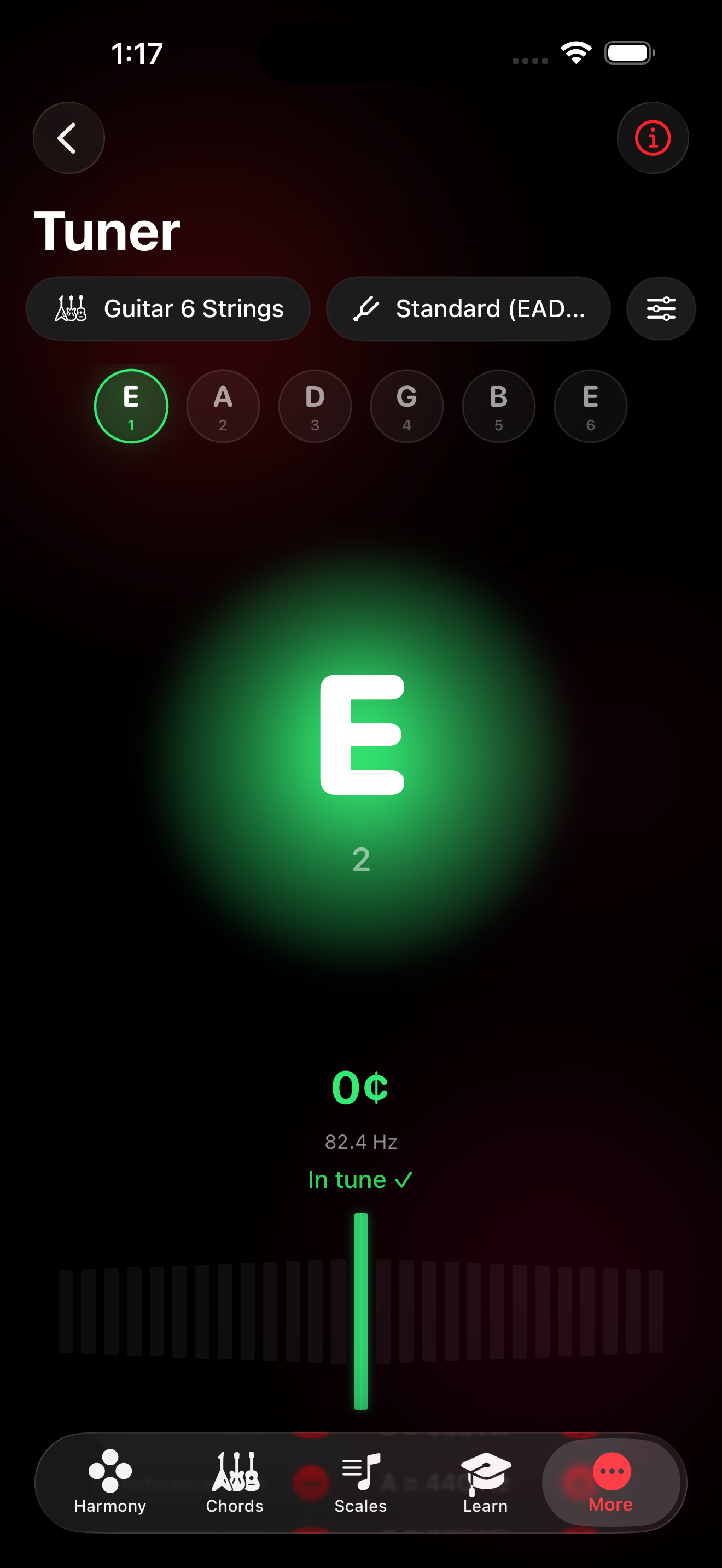 Tuner screen showing a glowing green in-tune indicator for the low E string at 82.4 Hz